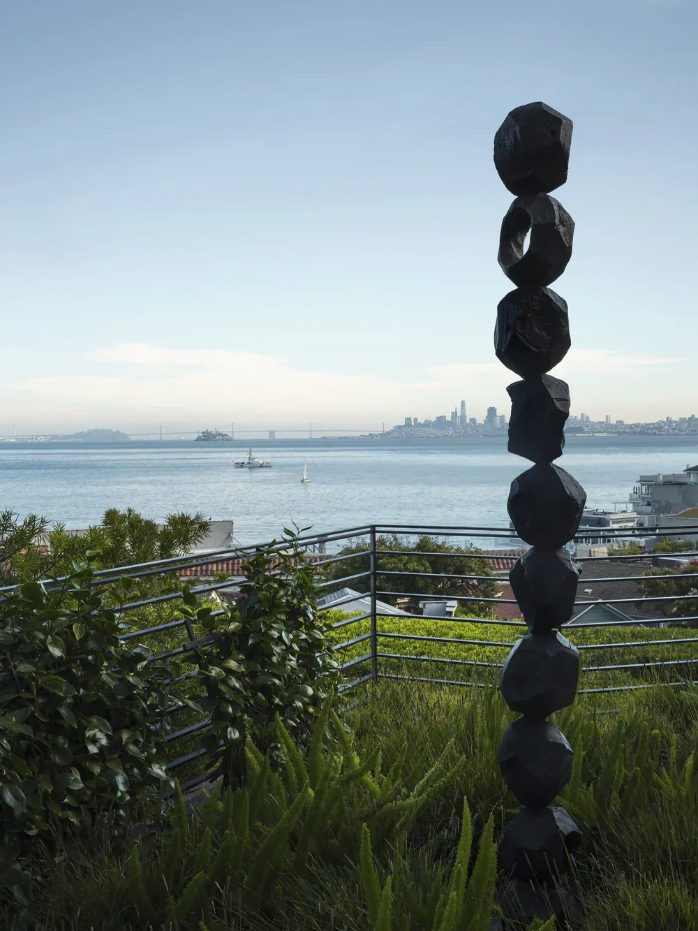 The green roof looking south — a stacked black sculpture against the bay, the San Francisco skyline on the horizon
