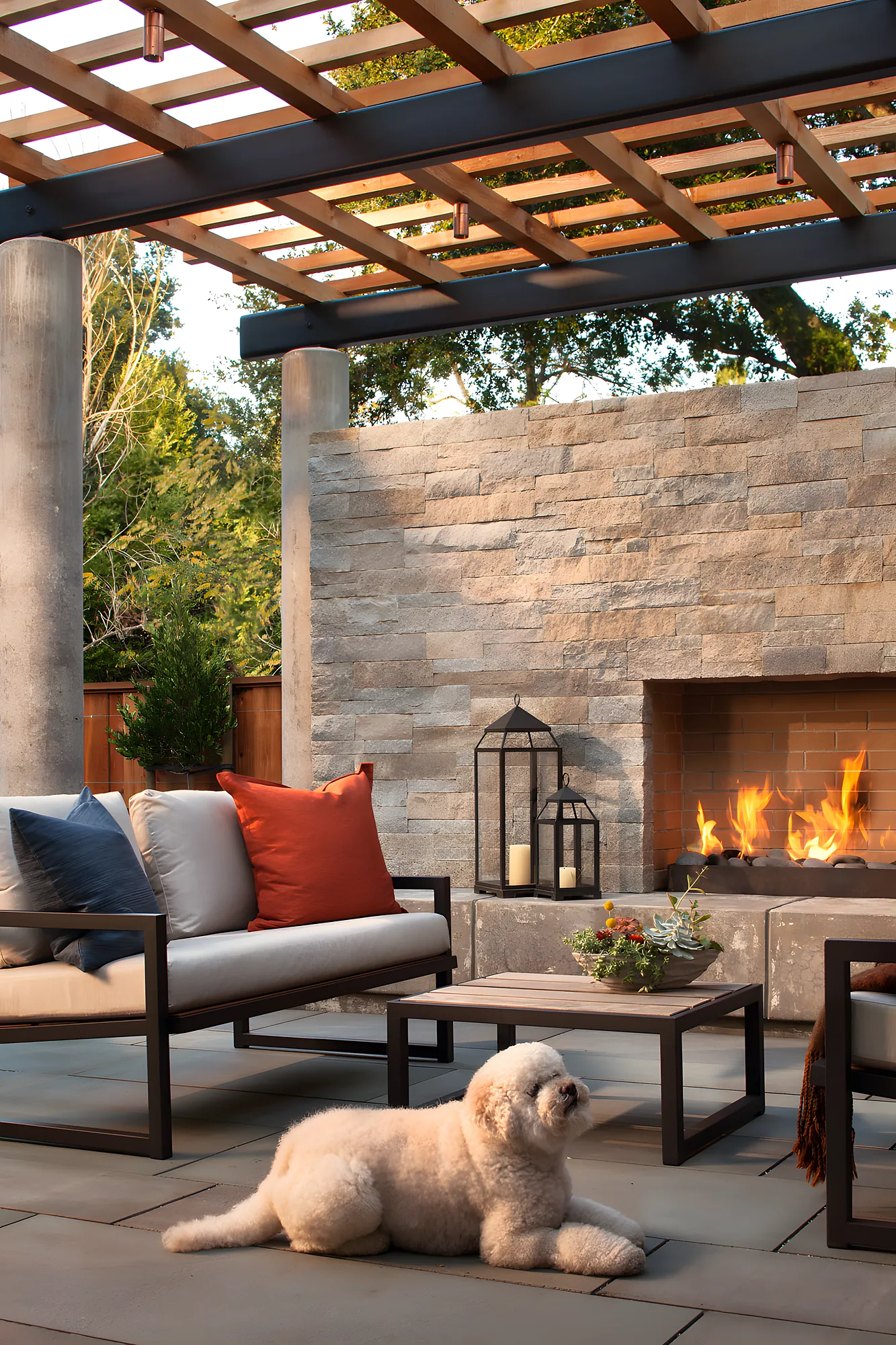 The owners' dog lying on the sofa under the arbor, the fire lit behind, a lantern on the hearth