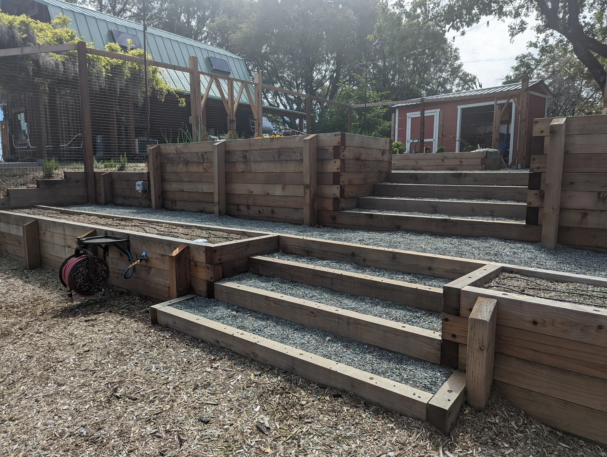 Stepped timber terraces carrying the planting down the hillside