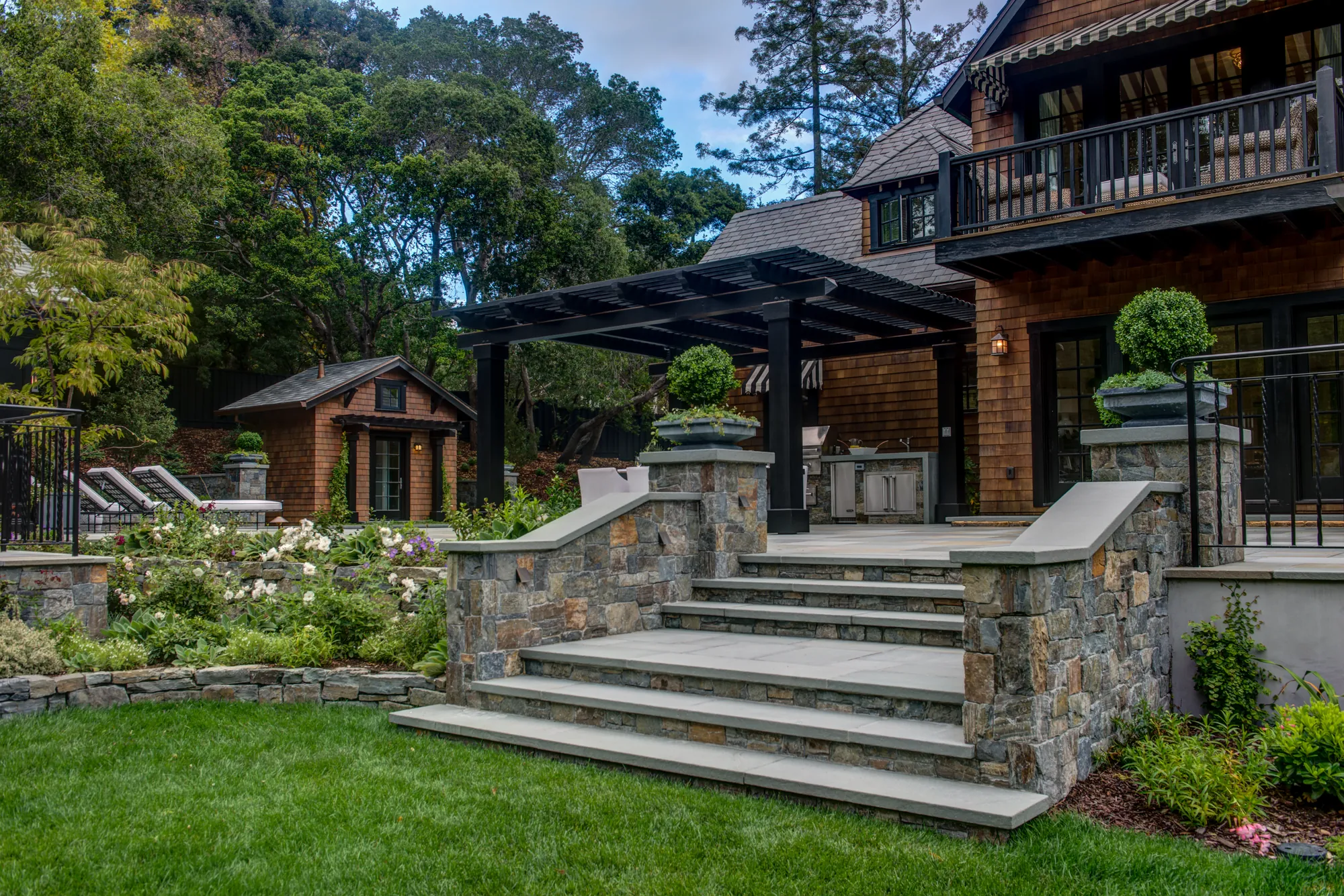 Orinda hillside residence — stone garden steps and pergola-topped outdoor kitchen edged with roses