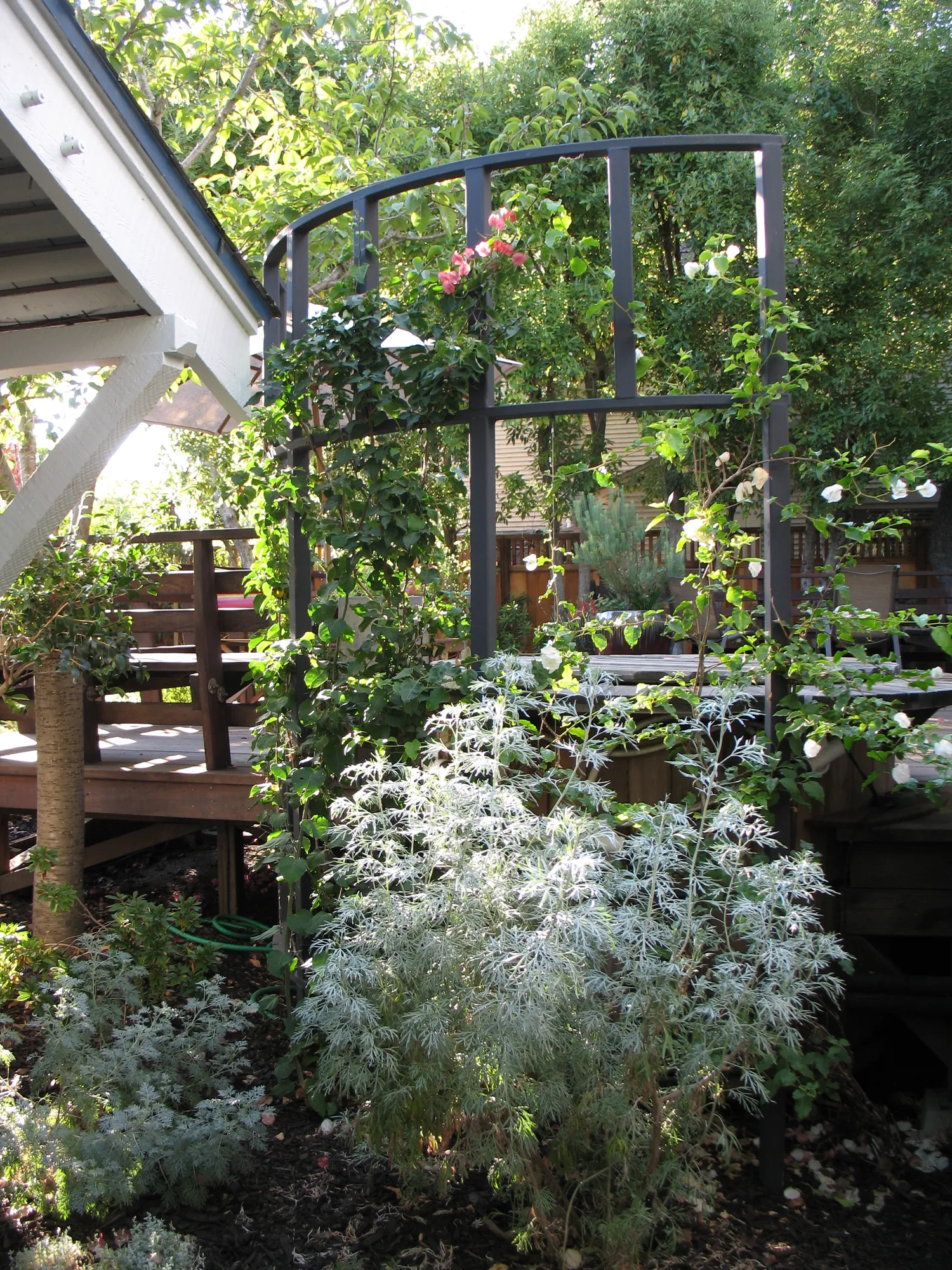 Custom wood screen giving the hot tub its own sheltered garden room